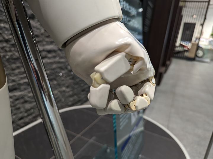 Honda's white ASIMO humanoid robot standing in a museum display