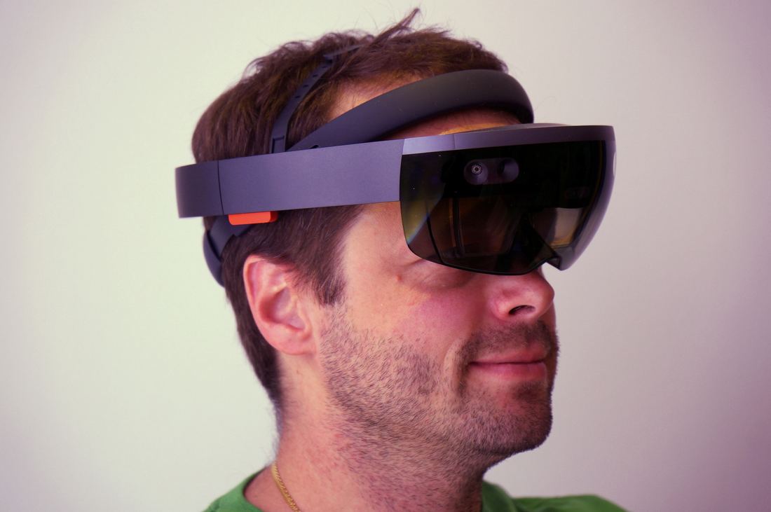 A person wearing a mixed reality headset with a wide visor