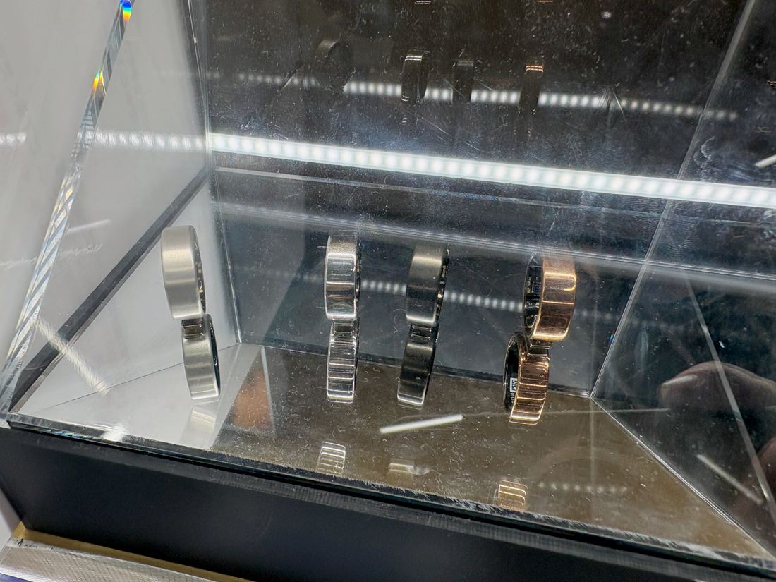 A slim metal smart ring on a store display